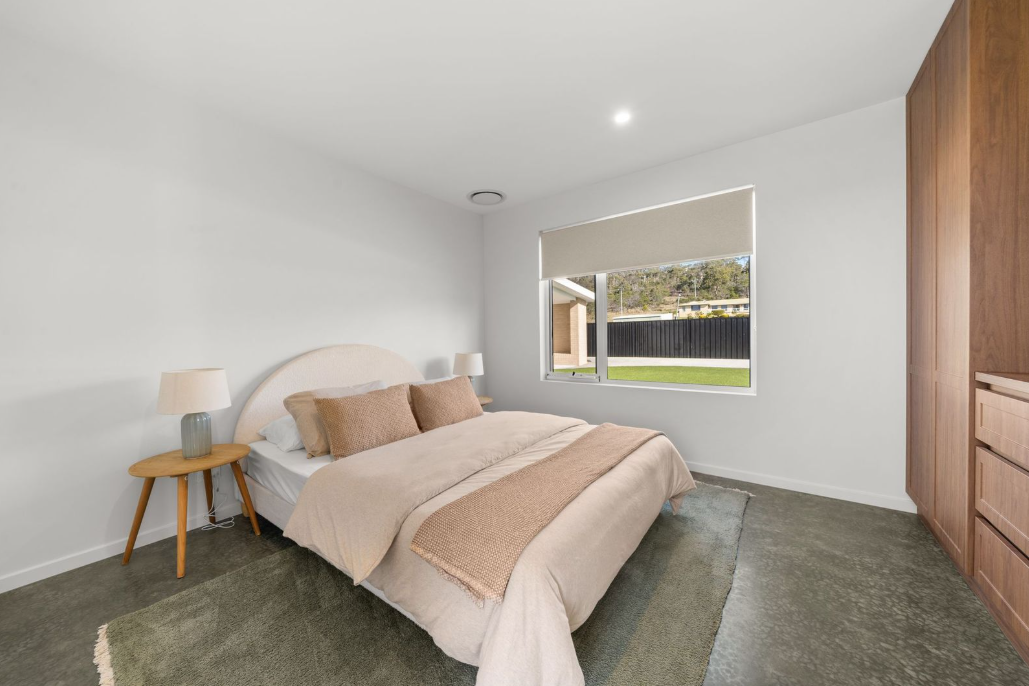 Natural-toned bedroom with curved bedhead