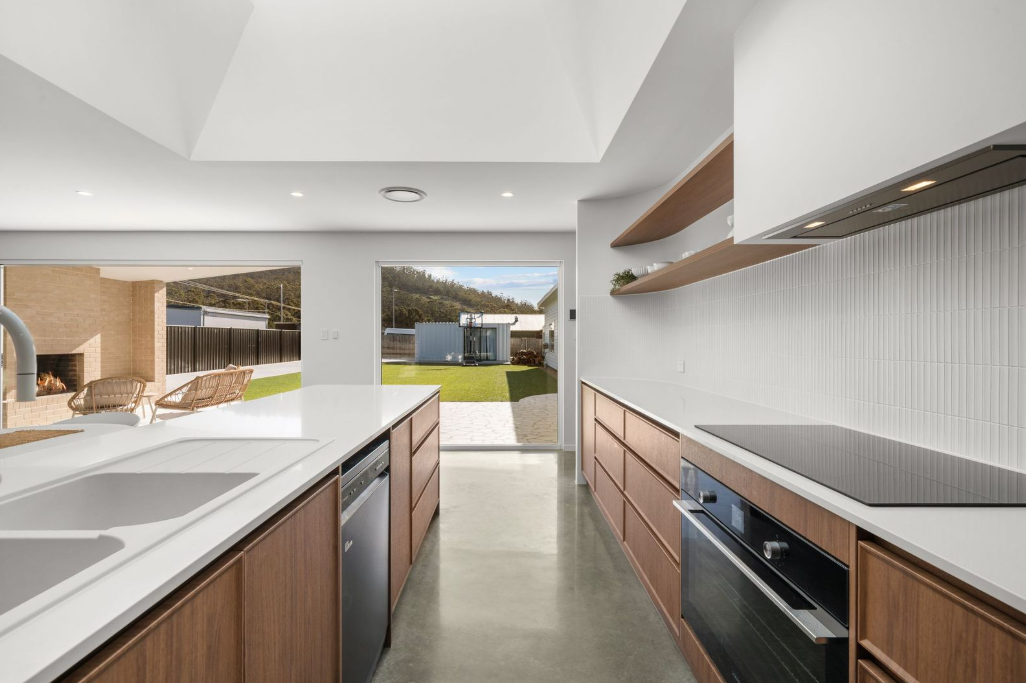 Timber galley kitchen opening to the courtyard